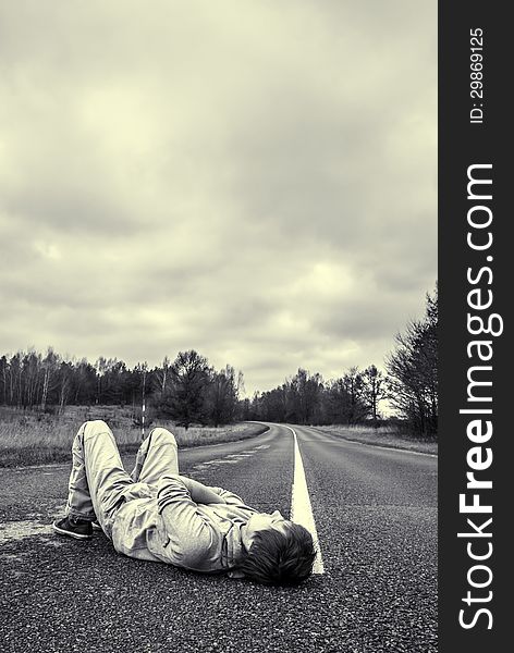 Young Guy Lies On The Road