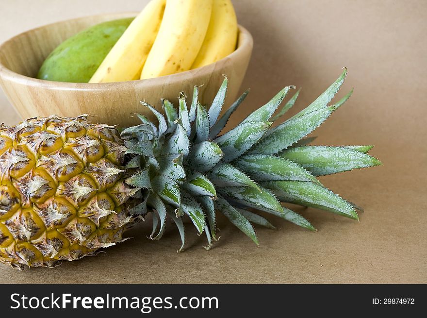 Tropical fruits pineapple with banana and mango bowl