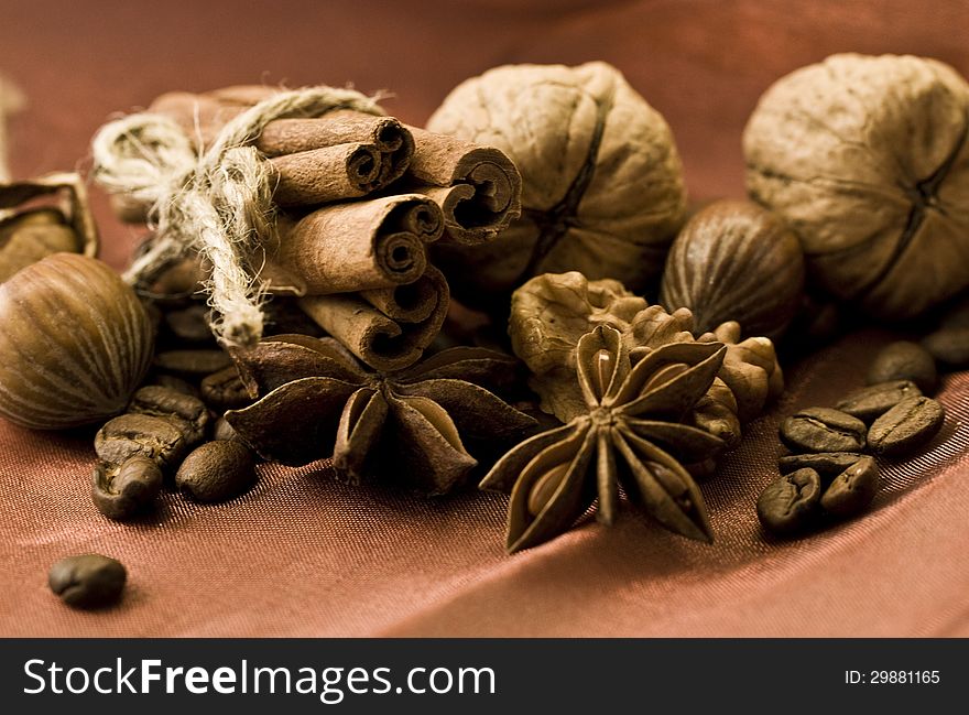 Closeup of walnuts, star anise and cinnamon on brown background. Closeup of walnuts, star anise and cinnamon on brown background