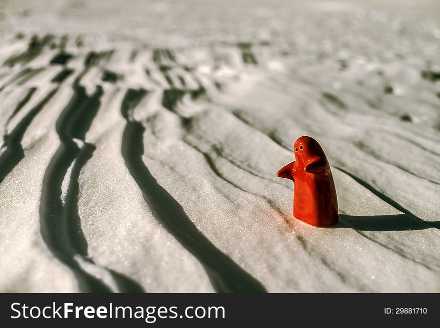 Little lonely red man stay on snow