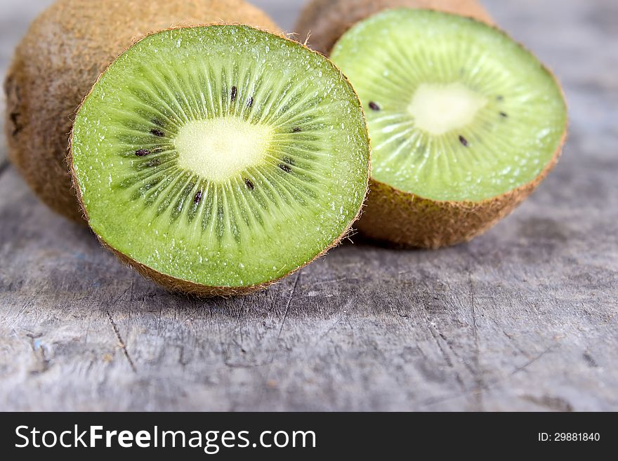 Close up of sliced fresh kiwi on wooden table top. Close up of sliced fresh kiwi on wooden table top