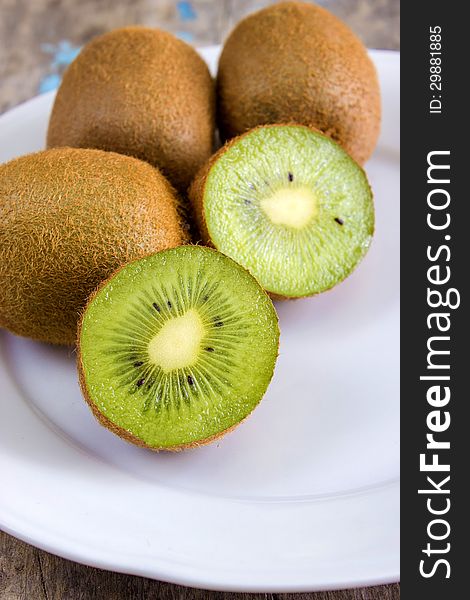 Close up of sliced fresh kiwi on white plate. Close up of sliced fresh kiwi on white plate
