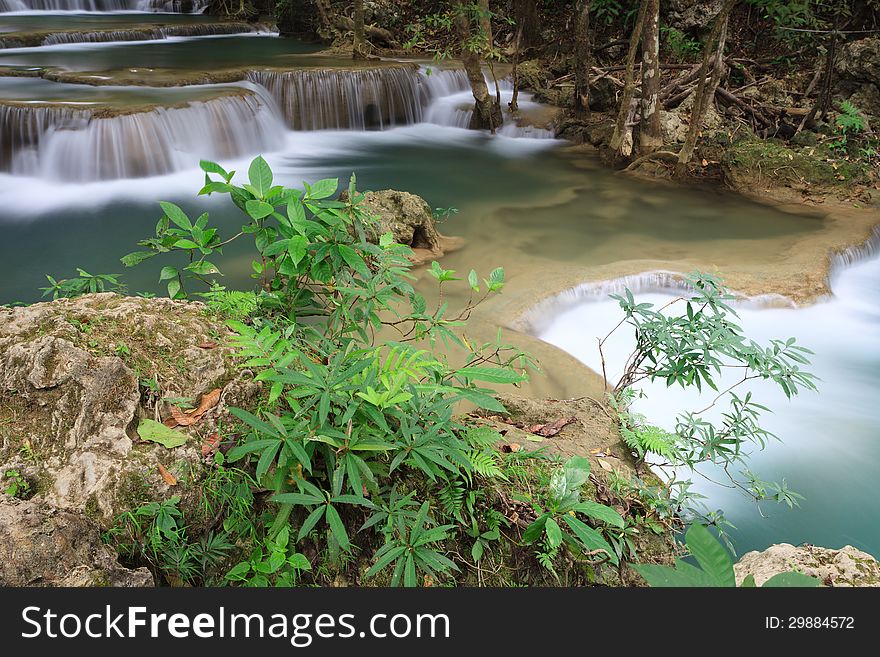 Small Trees on rocks and deep forest waterfall in Kanchanaburi, Thailand. Small Trees on rocks and deep forest waterfall in Kanchanaburi, Thailand