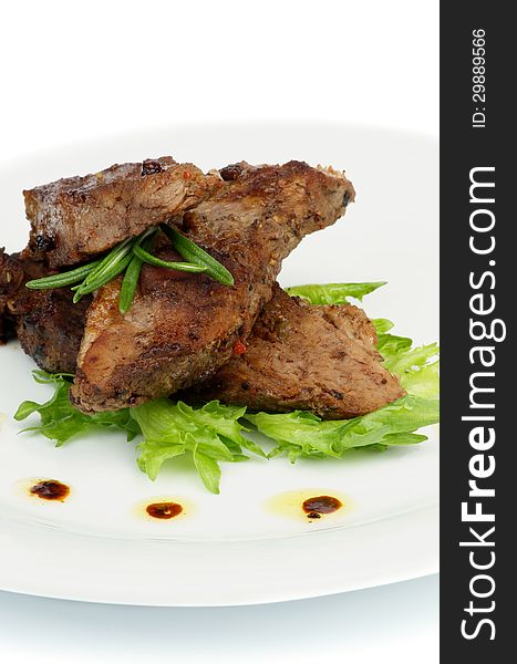 Three Slices of Delicious Roasted Beef with Spices and Rosemary on White Plate with Lettuce closeup