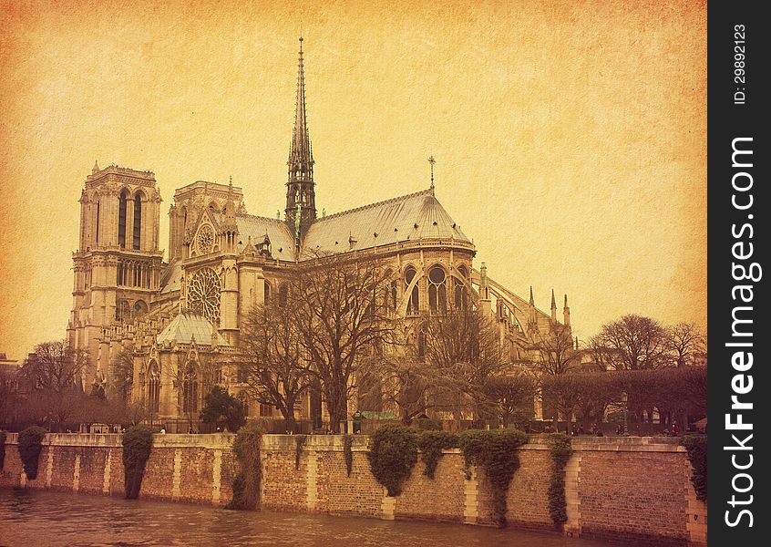 Notre Dame de Paris. View from the south. Photo in retro style. Paper texture.