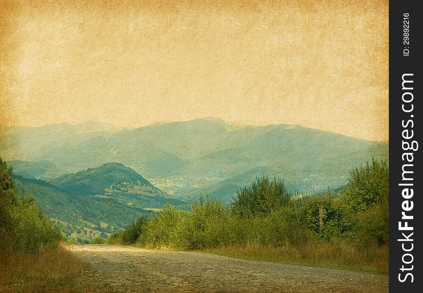 Country road in the mountains. Photo in retro style. Paper texture.