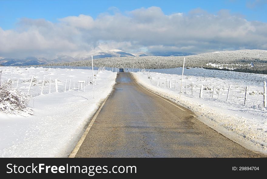 Long straight road middle of rural area in winter