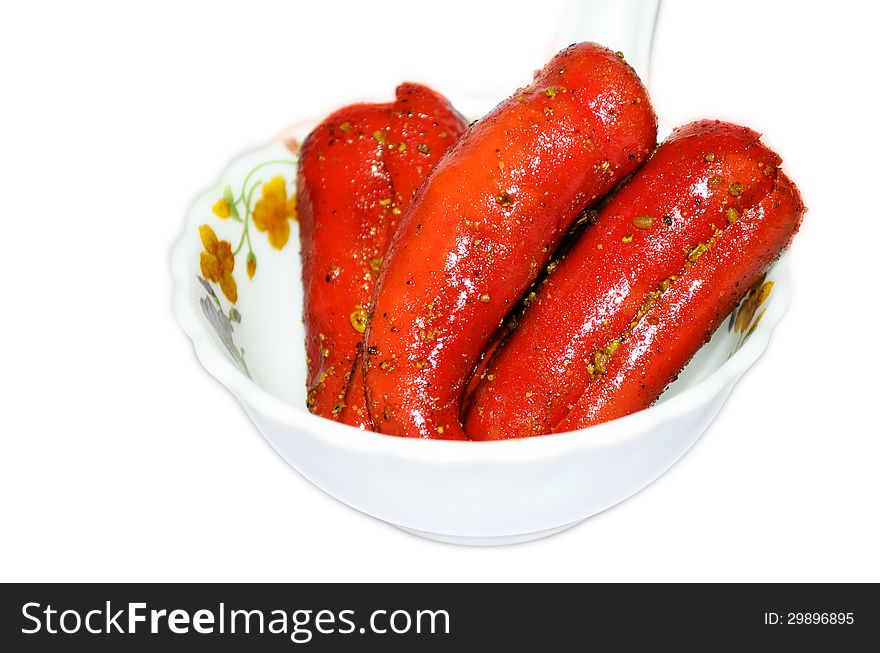 Red chillies pickle on bone china plate & bowl on isolated white background. Red chillies pickle on bone china plate & bowl on isolated white background