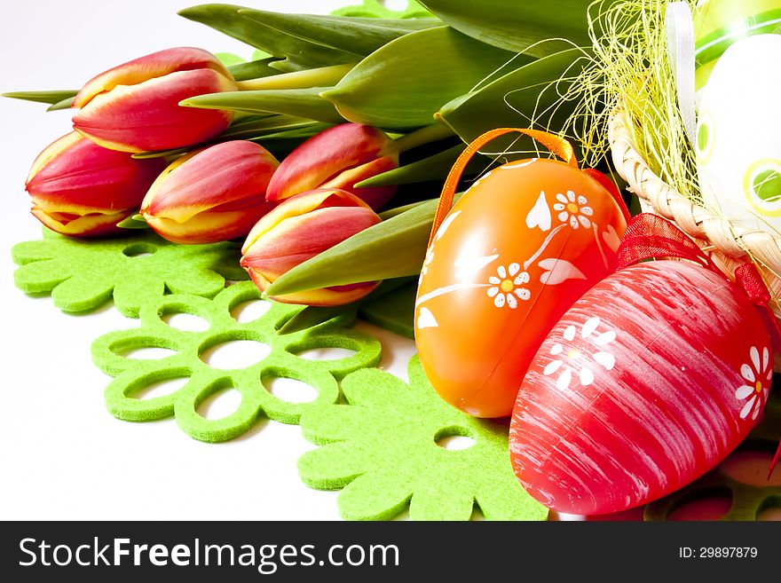 Colorful decorated easter eggs and fresh tulips. Colorful decorated easter eggs and fresh tulips