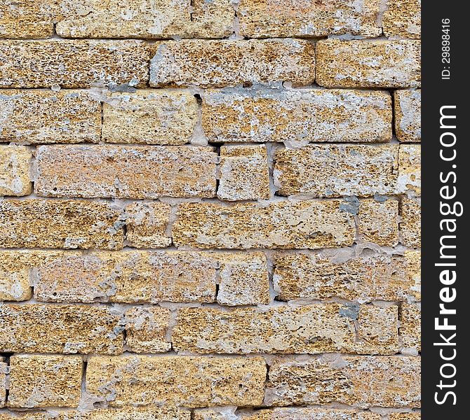 Sandstone Brick Wall with Cracks. Seamless Tileable Texture. Sandstone Brick Wall with Cracks. Seamless Tileable Texture.