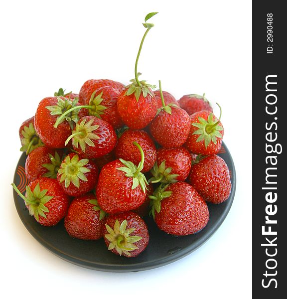 Plate with a strawberry on a white background. Plate with a strawberry on a white background.