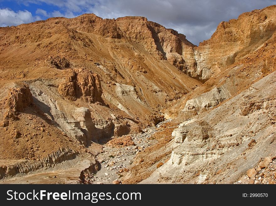 A dry channel of a stream in ancient mountains of the Dead Sea in Israel. A dry channel of a stream in ancient mountains of the Dead Sea in Israel