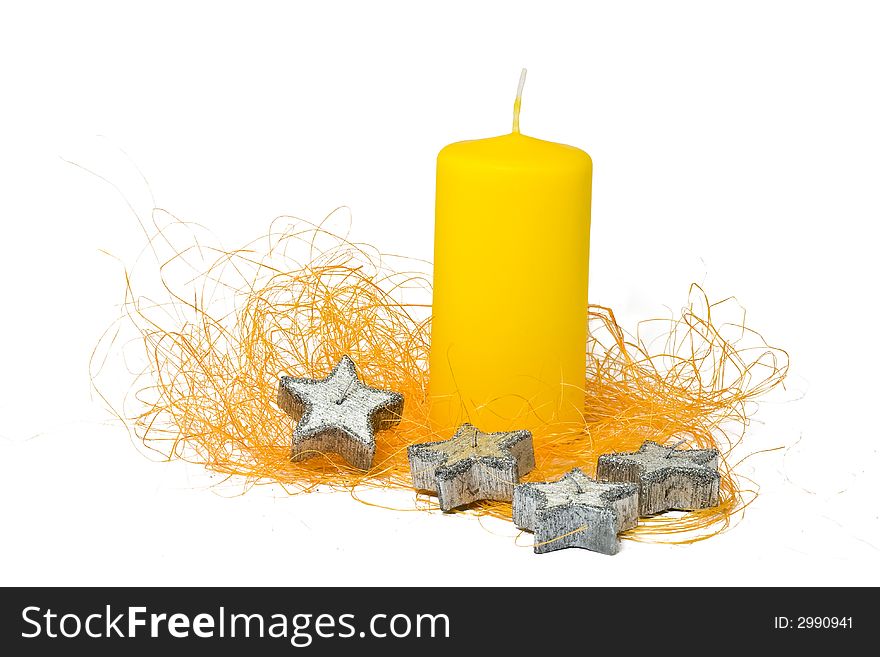 Big yellow candle with four silver star-shaped candles. Big yellow candle with four silver star-shaped candles