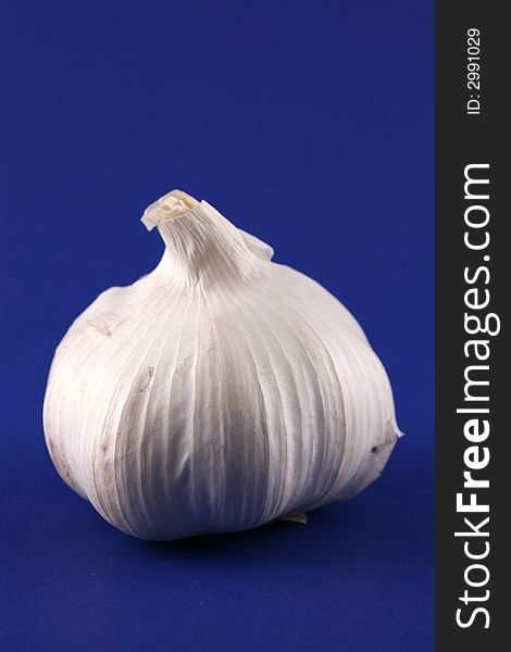 A bulb of garlic on a blue background