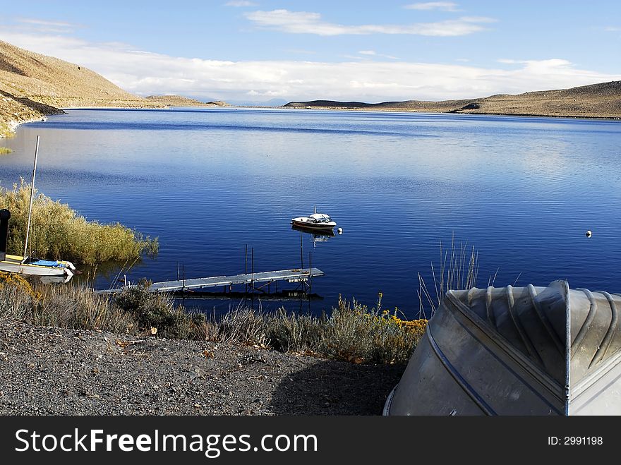 Tranquil mountain lake with dock and boats