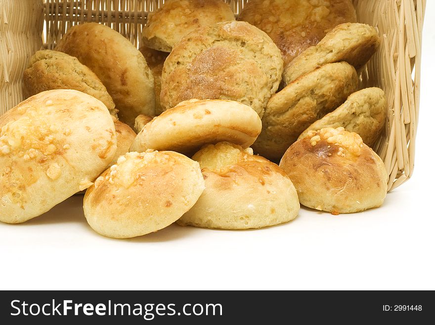 A basket of home-made bread isolated on white. A basket of home-made bread isolated on white.