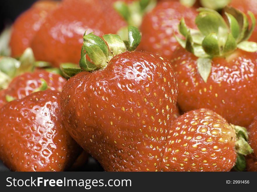 Fresh picked delicious red, ripe strawberries with green stems. Fresh picked delicious red, ripe strawberries with green stems