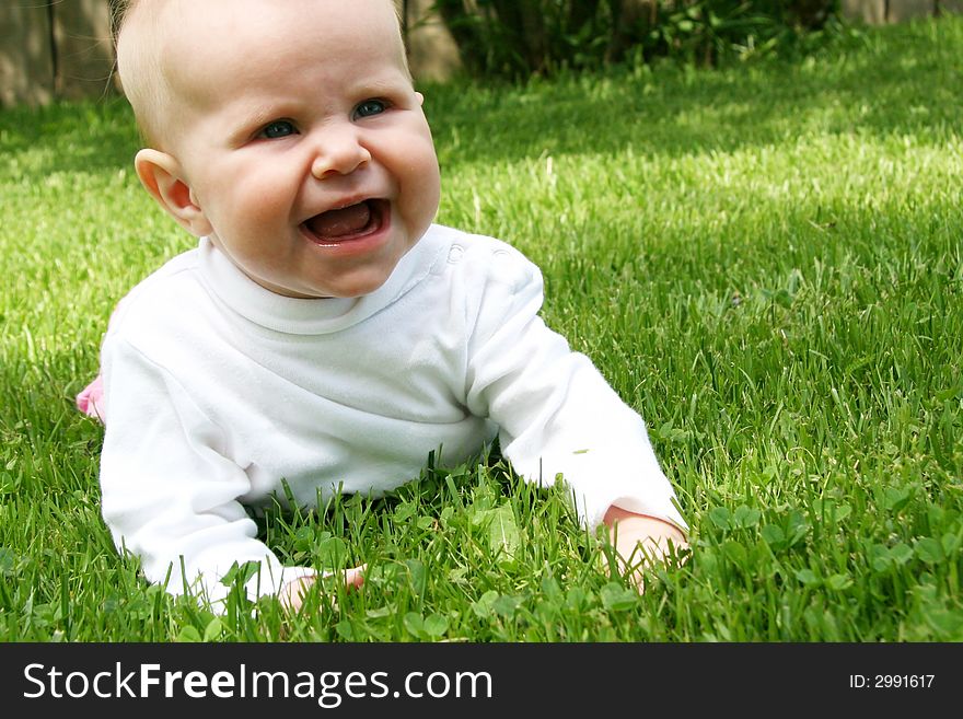 Little Baby Girl in grass in summer time