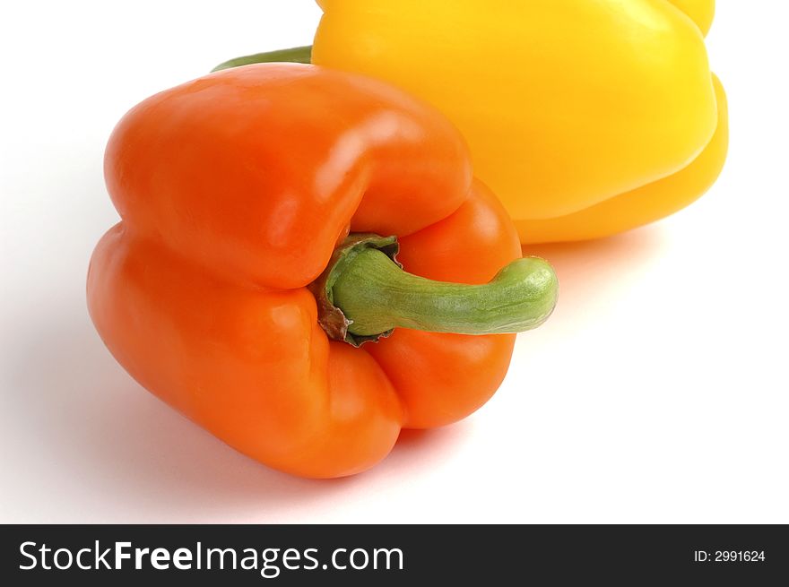 Orange and yellow peppers on a white background. Orange and yellow peppers on a white background.