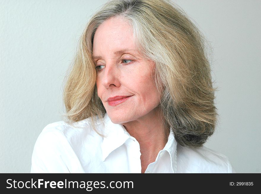 Portrait of a beautiful mature female relaxing at home. Portrait of a beautiful mature female relaxing at home.