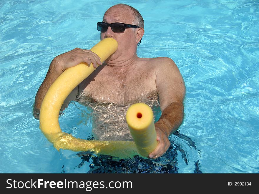 A man is having fun in the pool. A man is having fun in the pool