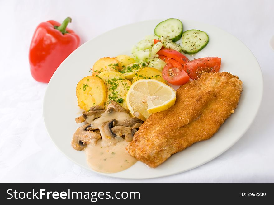 Viennese-milanese-steak with fried potatoes and salad