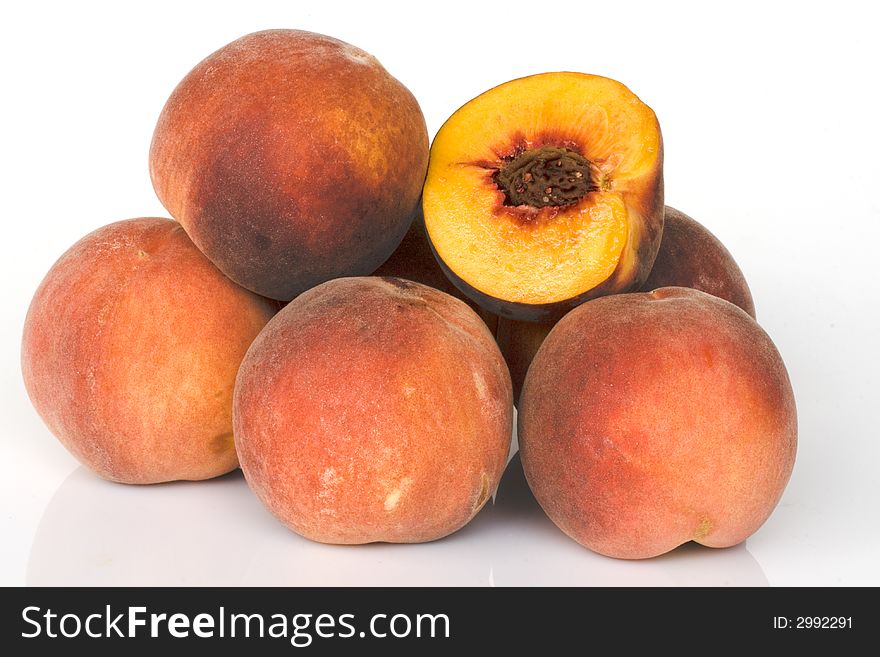 Fresh colored peaches on white background