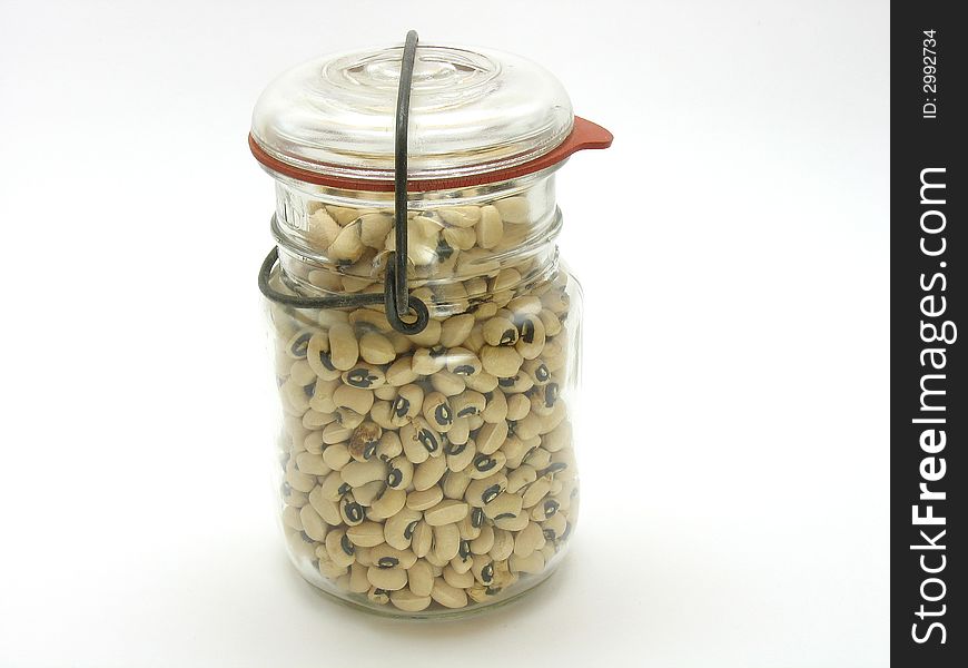 This is an old mason jar filled with beans photographed on a white background. This is an old mason jar filled with beans photographed on a white background.