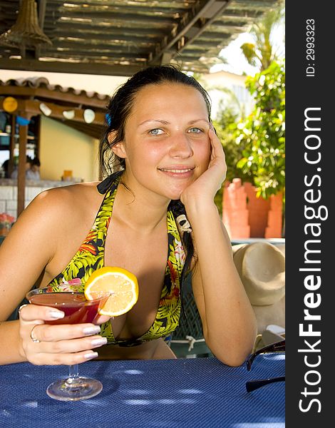 Young beautiful smiling woman with a cocktail. Young beautiful smiling woman with a cocktail