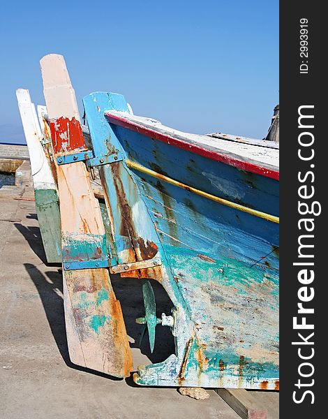 The steering helm of an old fishing boat which is resting out of the water. The steering helm of an old fishing boat which is resting out of the water