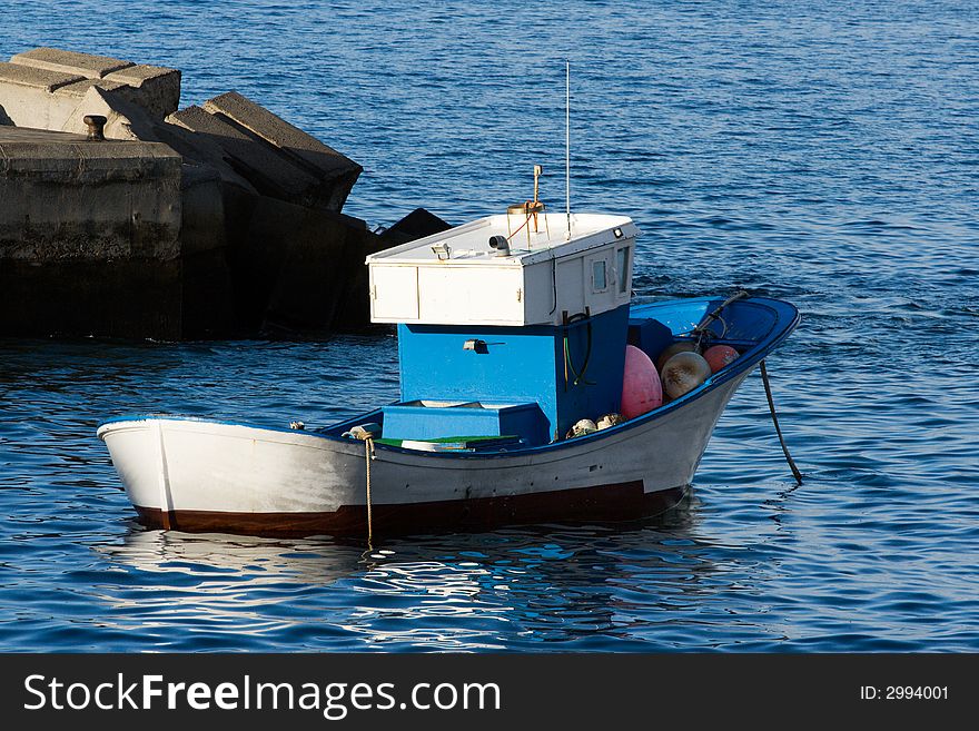 Fishing boat at anchor in a harbour. Fishing boat at anchor in a harbour