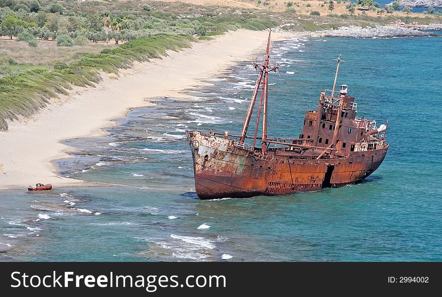 The rusty shipwreck on a coast near Gytheio, Greece. The rusty shipwreck on a coast near Gytheio, Greece