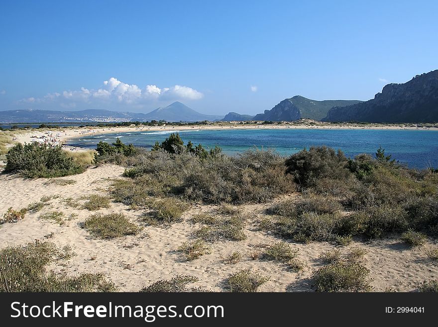 A wide-angle view of Voidokilia beach in Messinia area, Greece; the beach is considered one of the most beautiful in Europe, and its name means Ox belly (from its shape). A wide-angle view of Voidokilia beach in Messinia area, Greece; the beach is considered one of the most beautiful in Europe, and its name means Ox belly (from its shape)