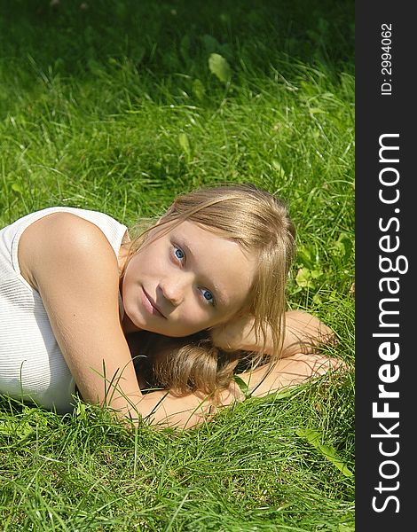 Young girl lying on the grass