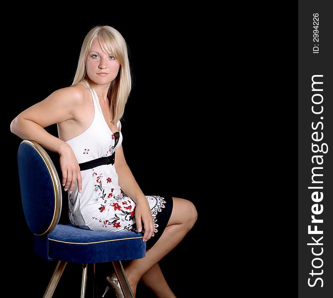 Beautiful young girl sitting on a chair. Beautiful young girl sitting on a chair