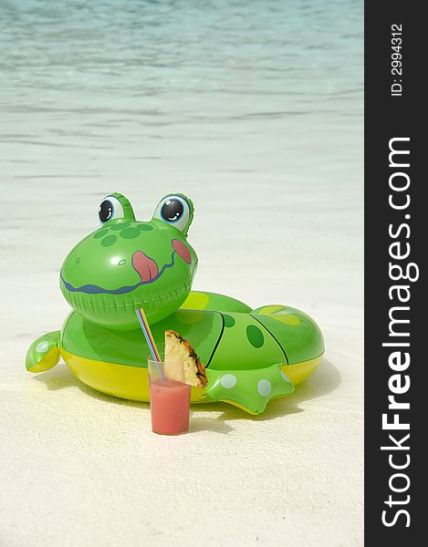 Happy frog is enjoying a cool drink by the pool. Happy frog is enjoying a cool drink by the pool
