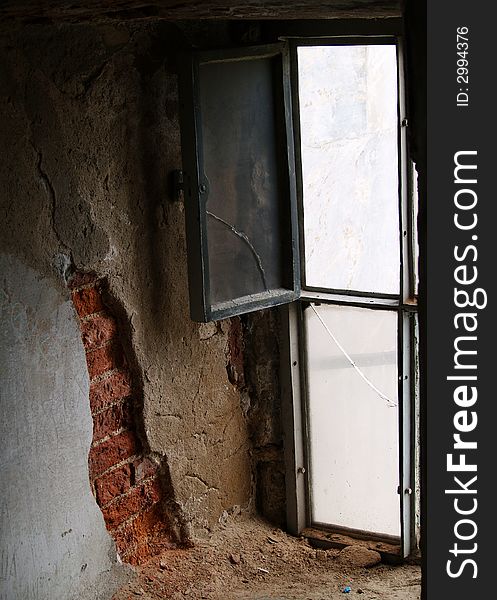 Open window with old frame beside the red bricks of the wall symbolize that in any situation you always have the way to go