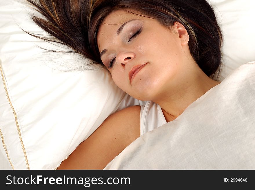 Close-up of attractive brunette woman in bed. Close-up of attractive brunette woman in bed