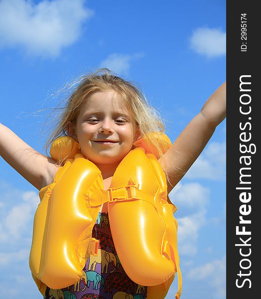 The happy girl in a life jacket