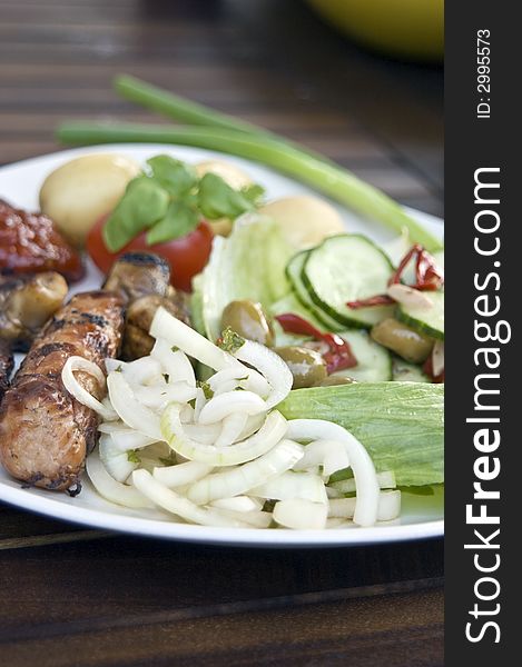 Sausage, mushrooms and fresh salad, focusing in on the fresh onions with mint. Sausage, mushrooms and fresh salad, focusing in on the fresh onions with mint