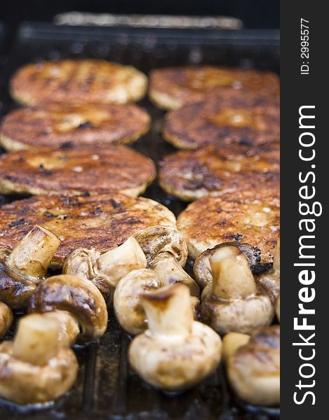A treat of hot mushrooms and burgers straight from the griddle on the gas barbecue. A treat of hot mushrooms and burgers straight from the griddle on the gas barbecue
