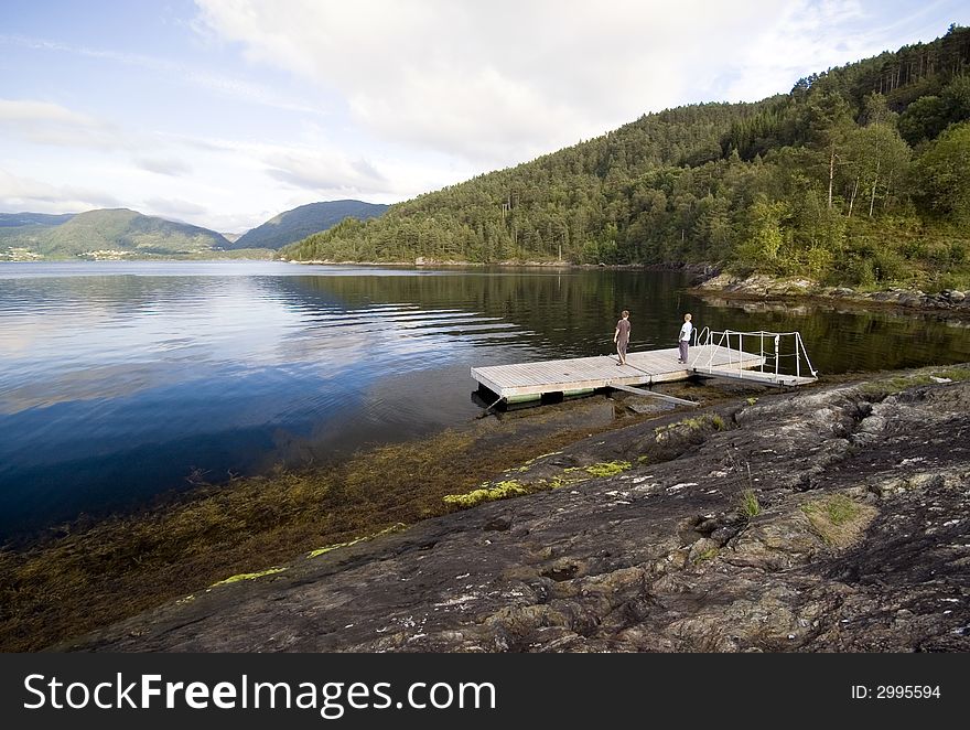 Two boys on a wooden jetty at a Norwegian fjord.

<a href='http://www.dreamstime.com/beauty-of-norway-rcollection5045-resi208938' STYLE='font-size:13px; text-decoration: blink; color:#FF0000'><b>BEAUTY OF NORWAY COLLECTION Â»</b></a>. Two boys on a wooden jetty at a Norwegian fjord.

<a href='http://www.dreamstime.com/beauty-of-norway-rcollection5045-resi208938' STYLE='font-size:13px; text-decoration: blink; color:#FF0000'><b>BEAUTY OF NORWAY COLLECTION Â»</b></a>