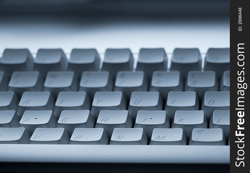 Focussed on front rows of computer keyboard with blurred background. Focussed on front rows of computer keyboard with blurred background