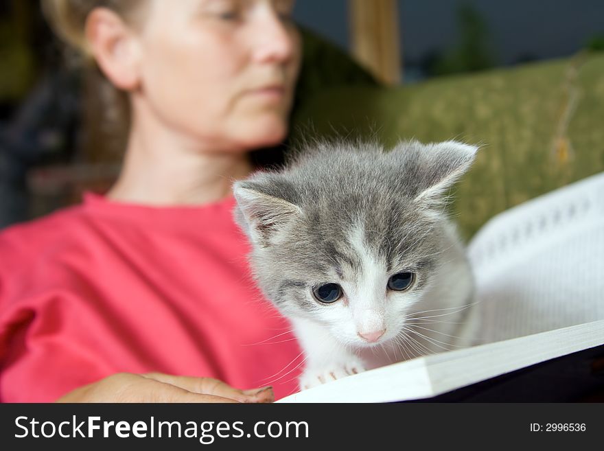 Woman reading book with cat. Woman reading book with cat