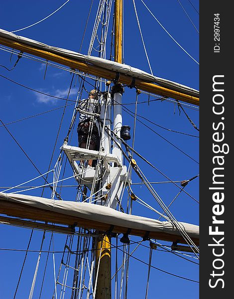 Sailor up in the crow's nest of a tall ship. Sailor up in the crow's nest of a tall ship