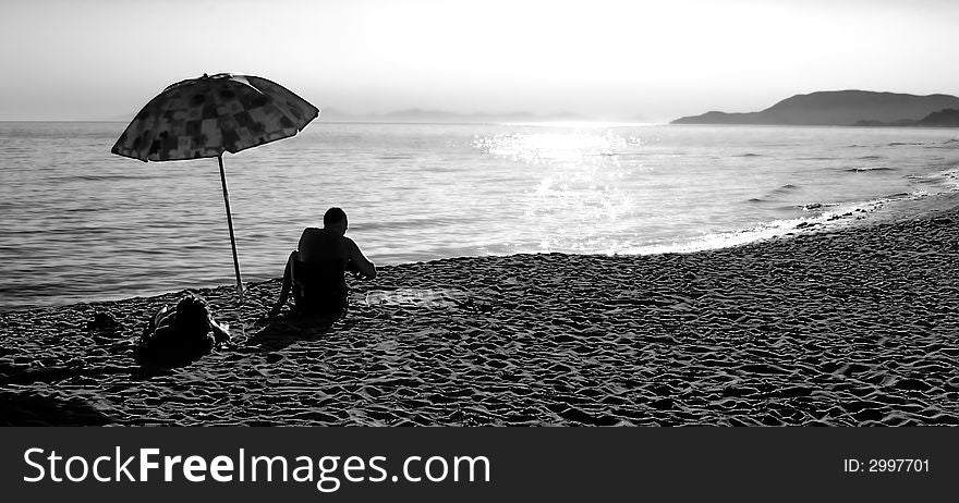 A couple is having fun on the beach at sunset. A couple is having fun on the beach at sunset