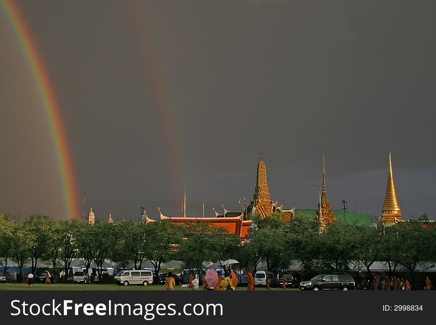 A storm just before sunset produces a dramatic rainbow against dark clouds over the Grand Palace and Wat Phra Kaeo in Bangkok. A storm just before sunset produces a dramatic rainbow against dark clouds over the Grand Palace and Wat Phra Kaeo in Bangkok.