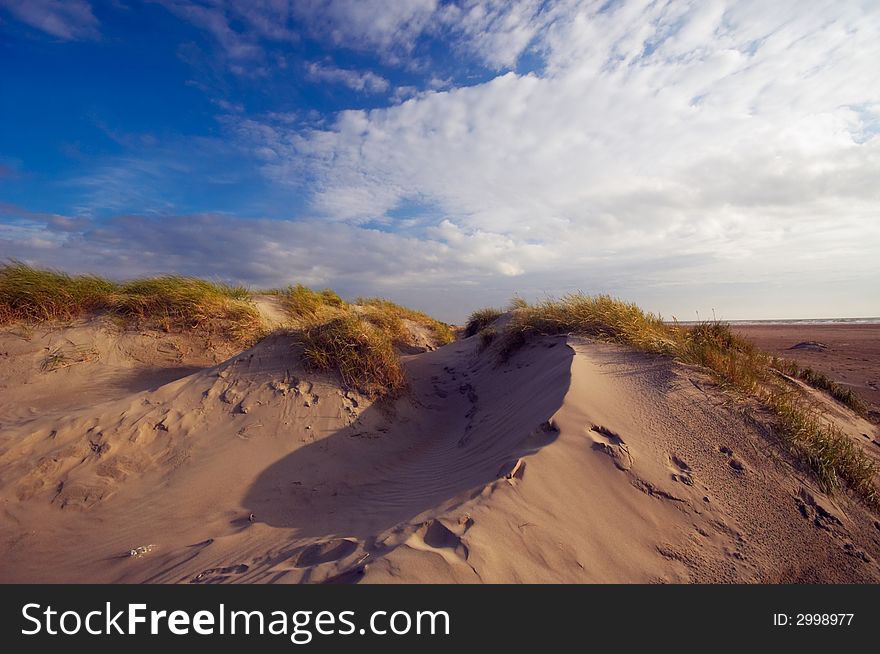 Blue sky sand dunes and ocean