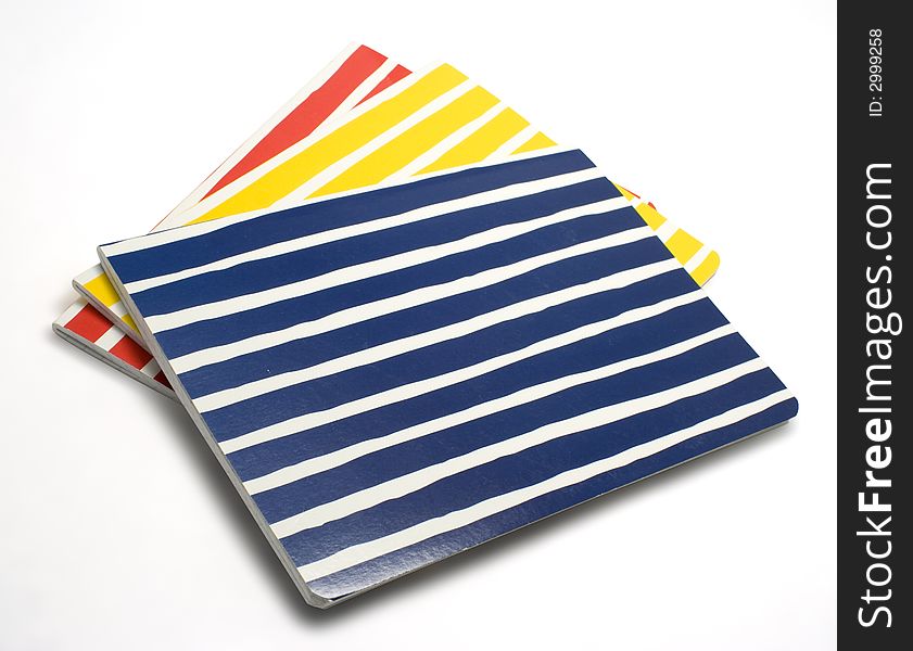 Colorful striped notebooks isolated on white