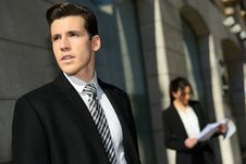 Attractive Young Businessmam And Businesswoman In Urban Background Royalty Free Stock Photography Attractive Young Businessmam And Businesswoman In Urban Background Royalty Free Stock Photography